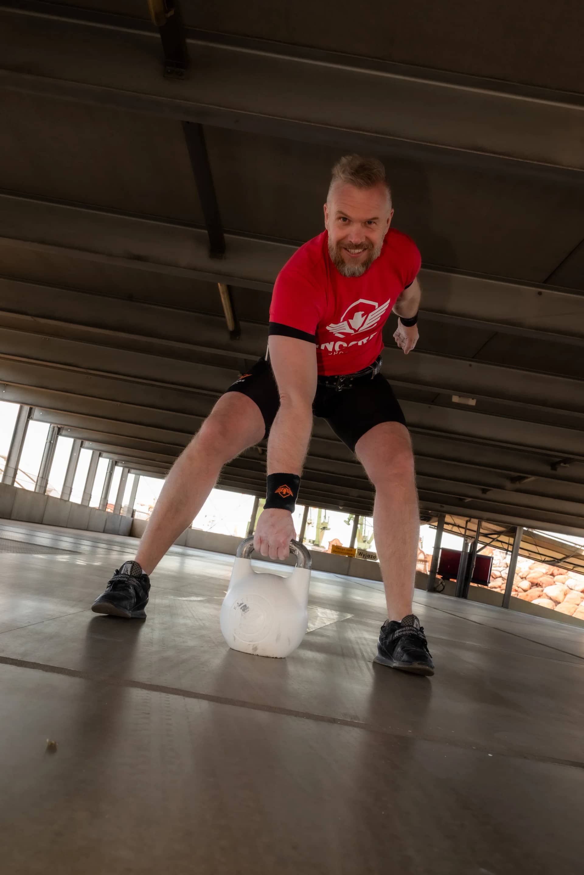 Athlete preparing for a kettlebell swing with an Incore Sports hardstyle bell